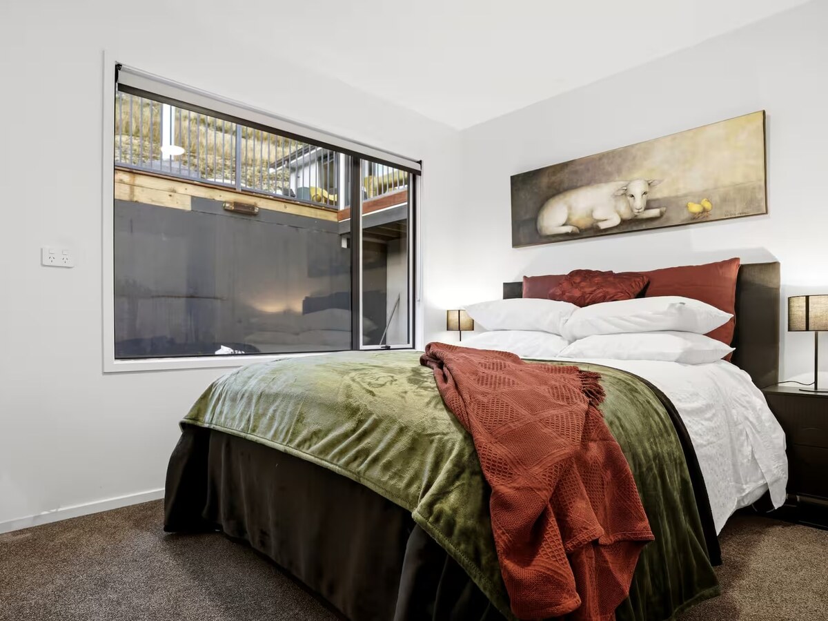 Bedroom before: a wide shot giving equal weight to empty floor space and the view outside